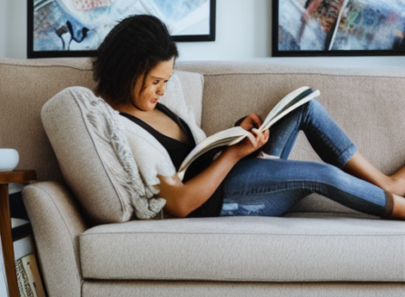 woman reading a book on a couch