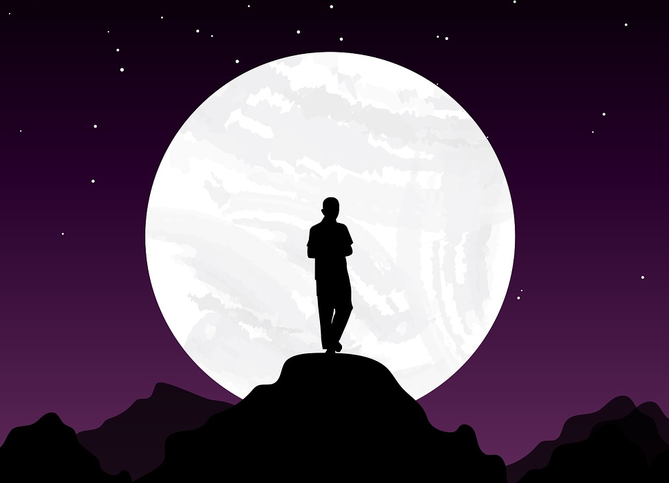 man standing in front of the moon